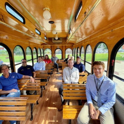 The mayor and several city workers riding the trolley